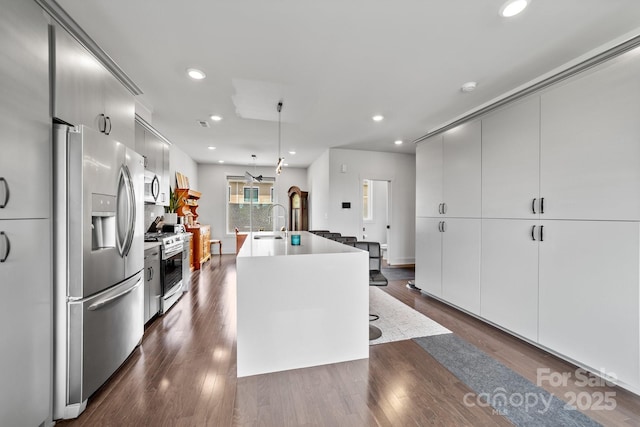 919 Cityscape Dr, Charlotte, NC 28205 - kitchen with stainless steel appliances, a sink, a center island with sink, recessed lighting, and dark wood-style floors