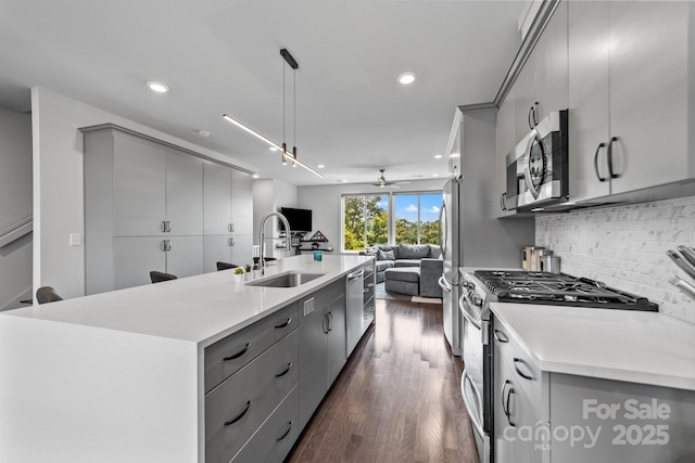 919 Cityscape Dr, Charlotte, NC 28205 - kitchen with gray cabinetry, stainless steel appliances, a sink, open floor plan, and an island with sink
