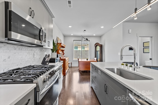 919 Cityscape Dr, Charlotte, NC 28205 - kitchen with appliances with stainless steel finishes, a sink, gray cabinetry, light countertops, and recessed lighting