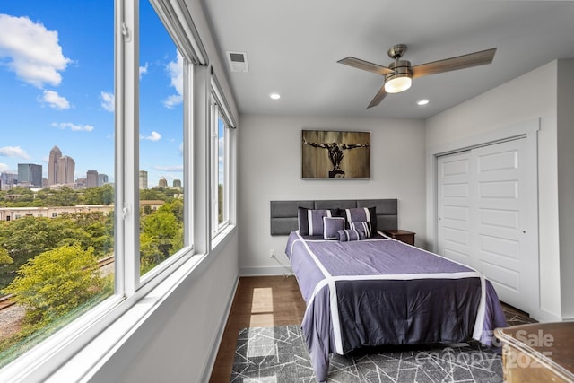 919 Cityscape Dr, Charlotte, NC 28205 - bedroom with dark wood finished floors, recessed lighting, baseboards, a view of skyline, and ceiling fan
