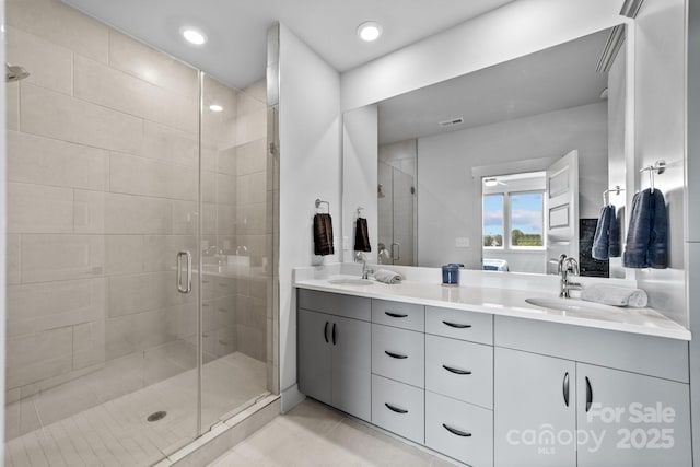 919 Cityscape Dr, Charlotte, NC 28205 - full bathroom featuring double vanity, a shower stall, tile patterned flooring, and recessed lighting