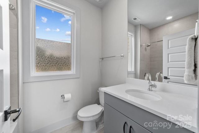 919 Cityscape Dr, Charlotte, NC 28205 - bathroom featuring vanity, toilet, a shower, and baseboards