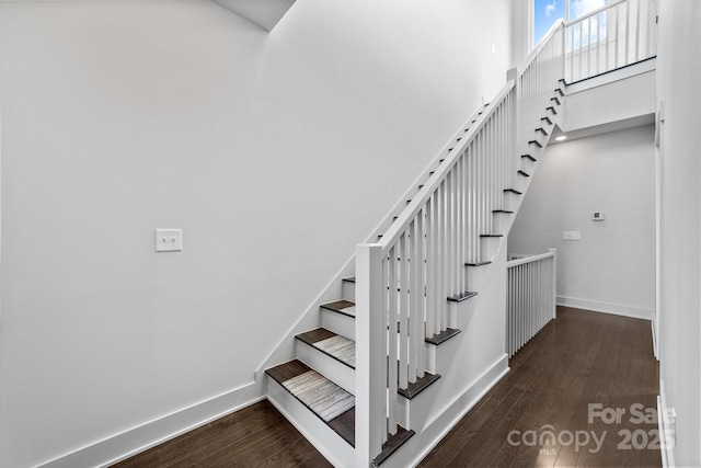 919 Cityscape Dr, Charlotte, NC 28205 - staircase featuring wood finished floors, baseboards, and a high ceiling