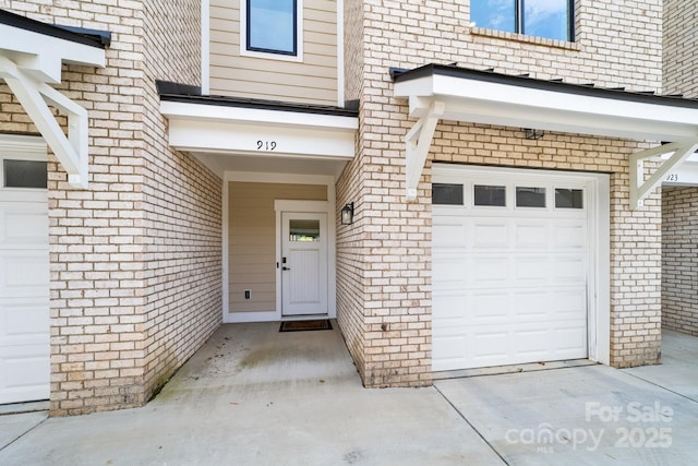 919 Cityscape Dr, Charlotte, NC 28205 - entrance to property featuring brick siding, a garage, and driveway