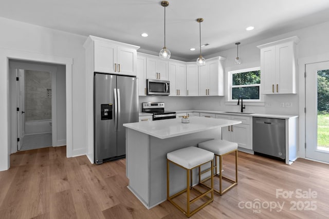 2220 Mooresville Rd, Salisbury, NC 28147 - kitchen featuring stainless steel appliances, a sink, white cabinets, light countertops, and recessed lighting