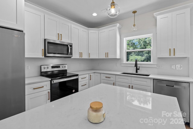 2220 Mooresville Rd, Salisbury, NC 28147 - kitchen with appliances with stainless steel finishes, a sink, white cabinetry, pendant lighting, and light stone counters
