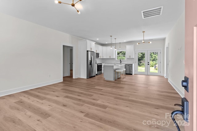 2220 Mooresville Rd, Salisbury, NC 28147 - kitchen with stainless steel appliances, open floor plan, white cabinetry, light countertops, and recessed lighting