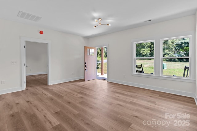 2220 Mooresville Rd, Salisbury, NC 28147 - spare room featuring light wood-style floors, baseboards, and a chandelier