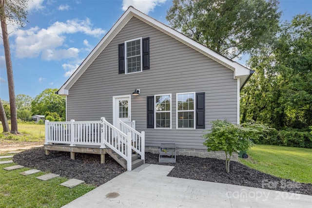 503 Apple St, Gibsonville, NC 27249 - back of house featuring a deck and a lawn