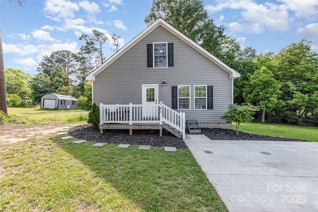 503 Apple St, Gibsonville, NC 27249 - view of front of house featuring a front yard, a wooden deck, and an outbuilding