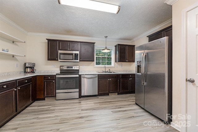 503 Apple St, Gibsonville, NC 27249 - kitchen with stainless steel appliances, light wood-style floors, ornamental molding, dark brown cabinetry, and open shelves