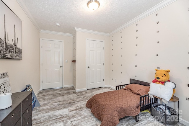503 Apple St, Gibsonville, NC 27249 - bedroom featuring light wood-style floors, a textured ceiling, ornamental molding, and baseboards