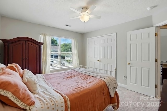 820 Settlement St, Clover, SC 29710 - bedroom featuring light carpet, ceiling fan, a closet, baseboards, and a textured ceiling