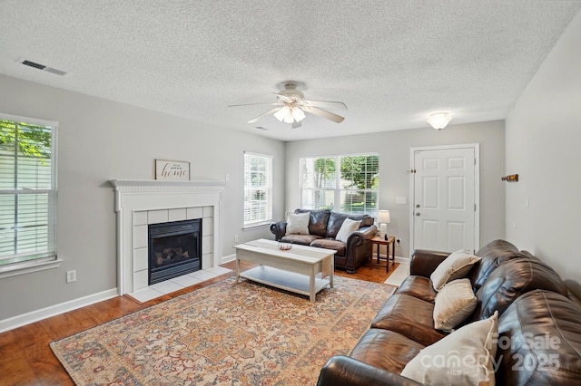 820 Settlement St, Clover, SC 29710 - living area featuring ceiling fan, wood finished floors, a textured ceiling, and a fireplace
