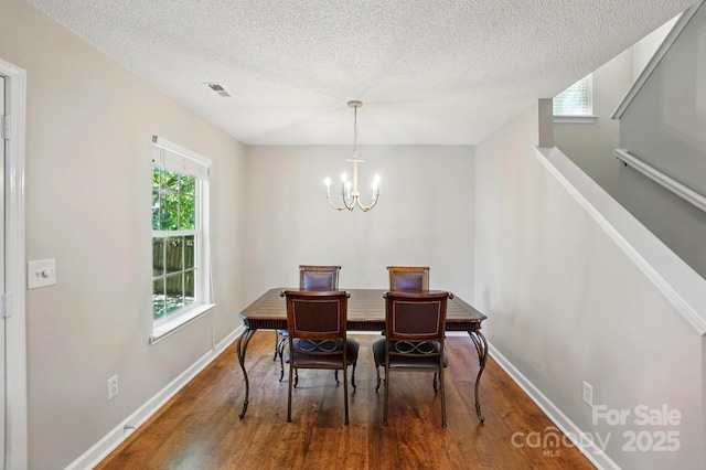 820 Settlement St, Clover, SC 29710 - dining room with wood finished floors, a chandelier, and a textured ceiling