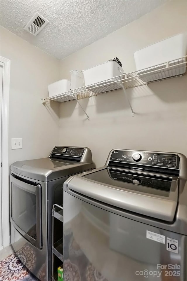 820 Settlement St, Clover, SC 29710 - laundry area featuring washer and clothes dryer and a textured ceiling