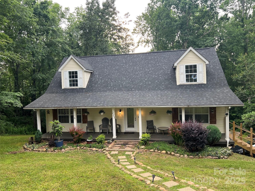 223 Tennessee Trl, Lincolnton, NC 28092 - view of front of home featuring covered porch, a front yard, and view of wooded area