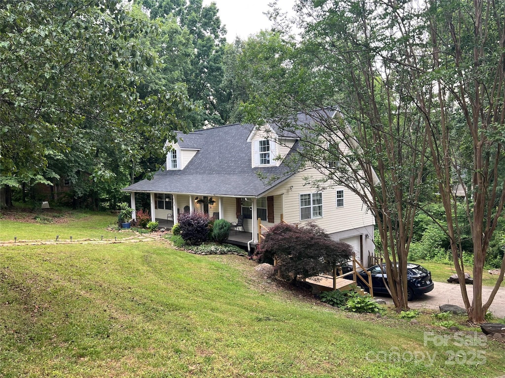223 Tennessee Trl, Lincolnton, NC 28092 - view of front of house with covered porch, a garage, a front yard, and a shingled roof