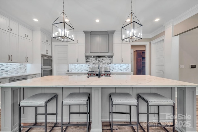 1622 Hunters Place Rd, York, SC 29745 - kitchen with a chandelier, stainless steel double oven, backsplash, a spacious island, and light stone countertops