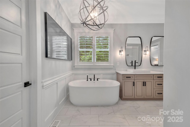 1622 Hunters Place Rd, York, SC 29745 - full bathroom with vanity, marble look tile flooring, a soaking tub, a chandelier, and wainscoting