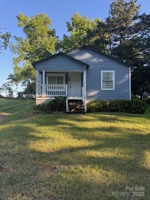 241 Hamrick Dr, Ellenboro, NC 28040 - view of front facade featuring a front yard and a porch