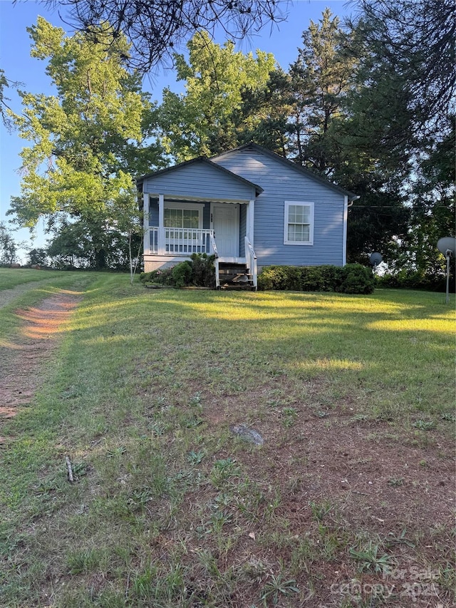 241 Hamrick Dr, Ellenboro, NC 28040 - view of front of home with a porch and a front lawn