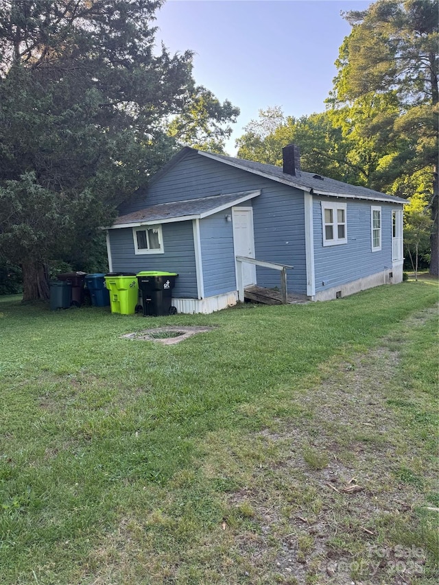 241 Hamrick Dr, Ellenboro, NC 28040 - rear view of house featuring a lawn and a chimney