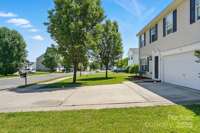 1005 Exodus Ct, Monroe, NC 28110 - view of green lawn featuring a garage, concrete driveway, and a residential view