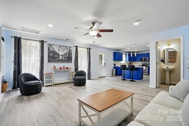 1005 Exodus Ct, Monroe, NC 28110 - living area with light wood finished floors, a ceiling fan, recessed lighting, and baseboards