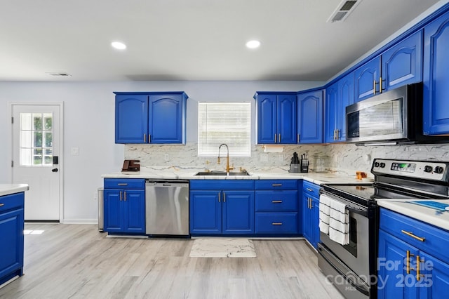 1005 Exodus Ct, Monroe, NC 28110 - kitchen with stainless steel appliances, a sink, backsplash, light wood-style floors, and recessed lighting