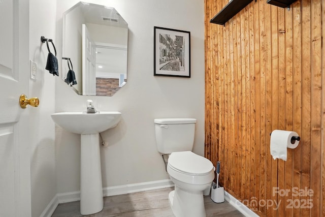 1005 Exodus Ct, Monroe, NC 28110 - half bathroom featuring toilet, wood finished floors, and baseboards