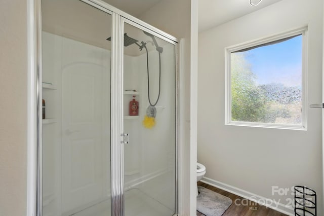 1005 Exodus Ct, Monroe, NC 28110 - bathroom with a shower stall, healthy amount of natural light, toilet, and wood finished floors