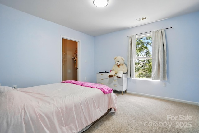 1005 Exodus Ct, Monroe, NC 28110 - carpeted bedroom with multiple windows, baseboards, and a walk in closet
