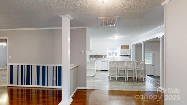 3151 Lynn Mountain Rd, Vale, NC 28168 - kitchen featuring white appliances, white cabinetry, wood finished floors, a textured ceiling, and light countertops