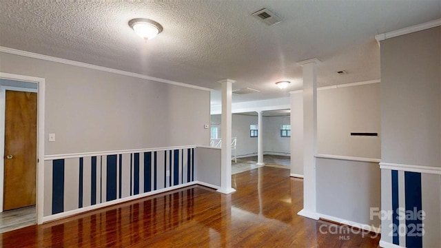3151 Lynn Mountain Rd, Vale, NC 28168 - empty room with decorative columns, wood finished floors, crown molding, and a textured ceiling