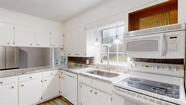 3151 Lynn Mountain Rd, Vale, NC 28168 - kitchen featuring white appliances, a sink, ornamental molding, white cabinets, and light stone countertops