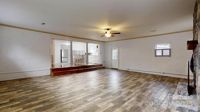 3151 Lynn Mountain Rd, Vale, NC 28168 - empty room with wood finished floors, a ceiling fan, brick wall, and crown molding