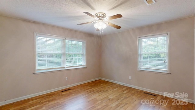 3151 Lynn Mountain Rd, Vale, NC 28168 - unfurnished room with plenty of natural light, wood finished floors, baseboards, and a textured ceiling