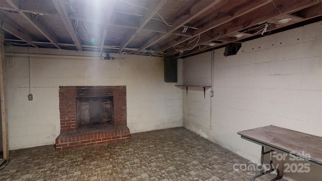 3151 Lynn Mountain Rd, Vale, NC 28168 - unfinished below grade area featuring tile patterned floors, a brick fireplace, and concrete block wall
