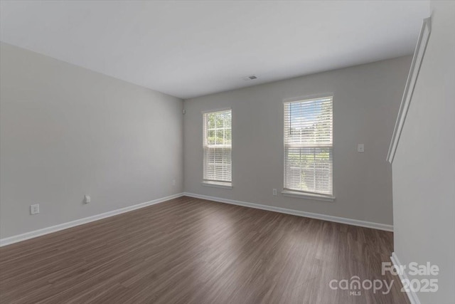 1111 Balcorn Pl, Charlotte, NC 28214 - spare room with baseboards and dark wood-type flooring