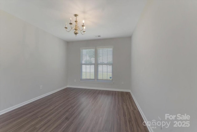 1111 Balcorn Pl, Charlotte, NC 28214 - empty room with a chandelier, baseboards, and dark wood-style flooring