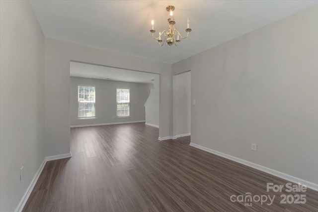 1111 Balcorn Pl, Charlotte, NC 28214 - unfurnished room with a chandelier, baseboards, and dark wood-style flooring