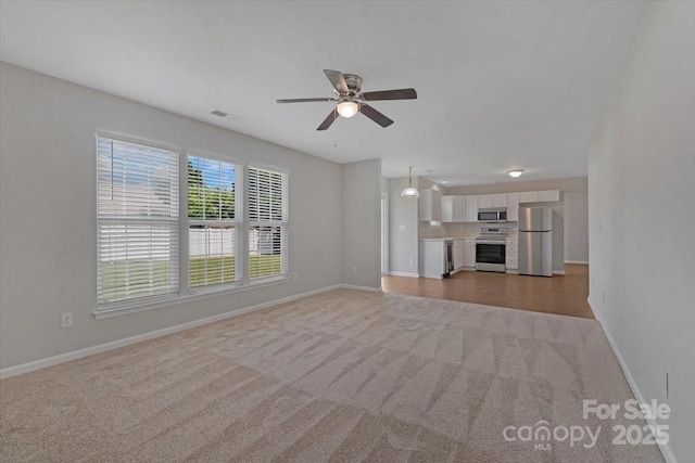 1111 Balcorn Pl, Charlotte, NC 28214 - unfurnished living room featuring carpet flooring, baseboards, and a ceiling fan