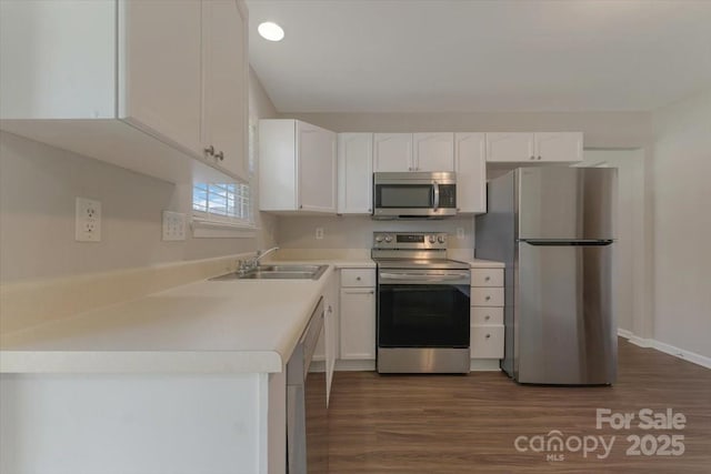 1111 Balcorn Pl, Charlotte, NC 28214 - kitchen featuring appliances with stainless steel finishes, a sink, white cabinetry, dark wood-style flooring, and light countertops