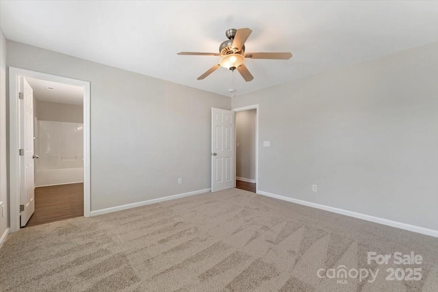 1111 Balcorn Pl, Charlotte, NC 28214 - unfurnished bedroom with carpet flooring, baseboards, ensuite bath, and a ceiling fan