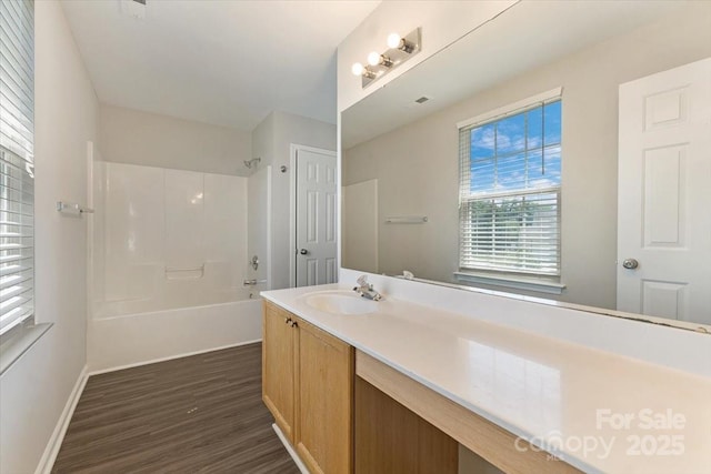 1111 Balcorn Pl, Charlotte, NC 28214 - bathroom with wood finished floors, vanity,  shower combination, and baseboards