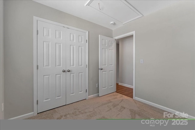 1111 Balcorn Pl, Charlotte, NC 28214 - unfurnished bedroom featuring attic access, carpet floors, a closet, and baseboards