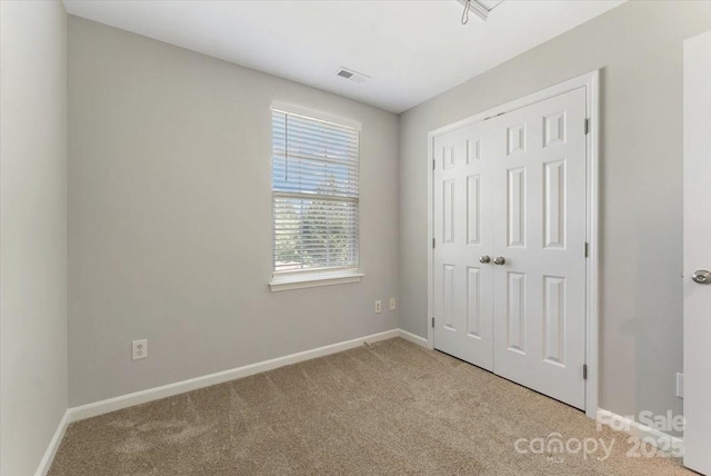 1111 Balcorn Pl, Charlotte, NC 28214 - unfurnished bedroom featuring carpet floors, baseboards, and a closet