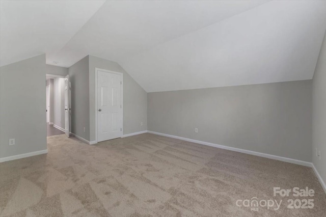 1111 Balcorn Pl, Charlotte, NC 28214 - additional living space with carpet, vaulted ceiling, and baseboards