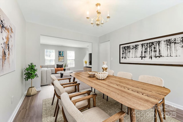1111 Balcorn Pl, Charlotte, NC 28214 - dining room featuring baseboards, a chandelier, and wood finished floors